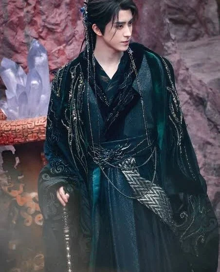 Человек в традиционной восточной одежде на фоне скал