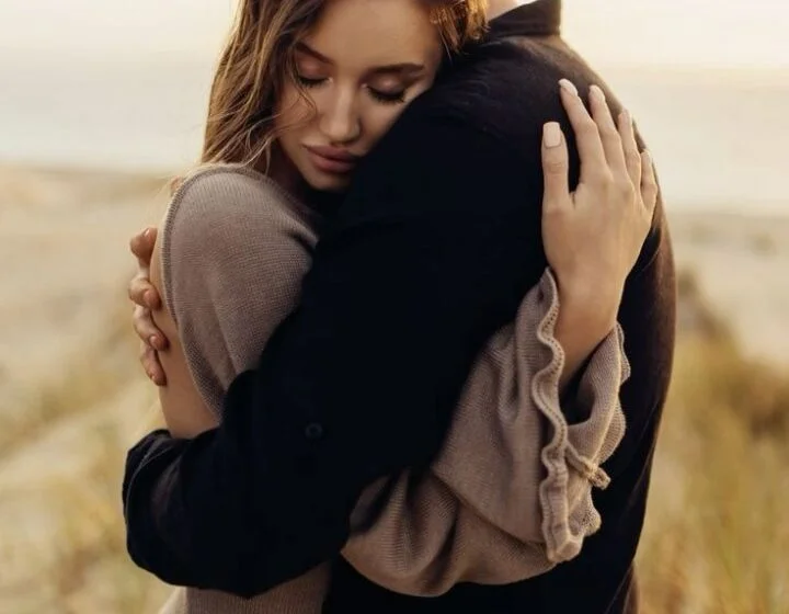 Пара обнимается на пляже, романтический момент